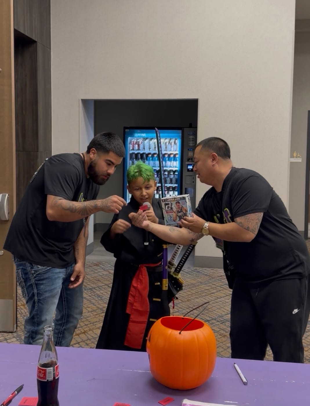 A young attendee drawing a raffle ticket and winning a box of trading cards